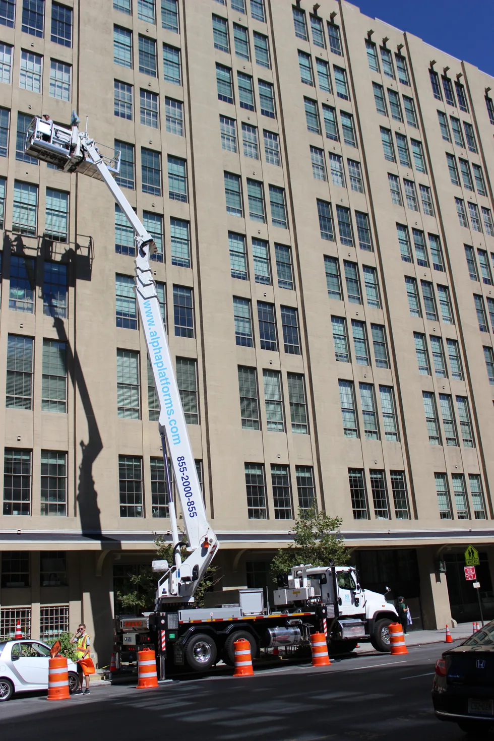 Aerial work platforms beside a multi-storey building